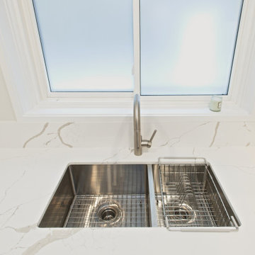 Double Stainless Kitchen Sink Beneath a Broad Window | North York