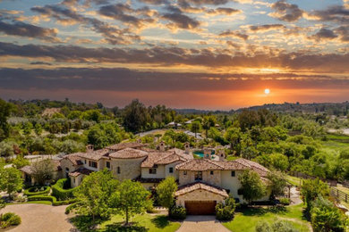 Huge mediterranean two-story exterior home idea in San Diego