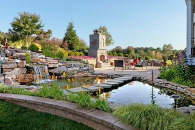 Inspiration for a mid-sized timeless backyard stone patio remodel with a fire pit and no cover