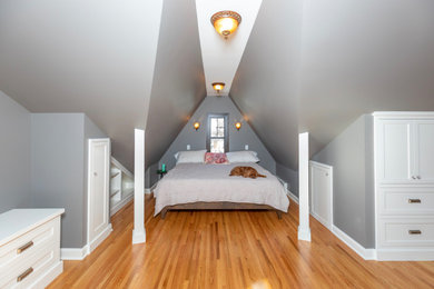 Example of a huge classic master medium tone wood floor bedroom design in Minneapolis