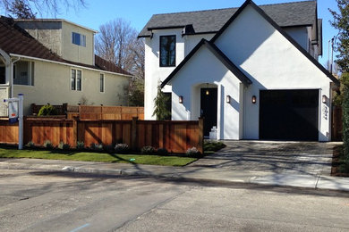 Mid-sized elegant white two-story stucco exterior home photo in Vancouver with a shingle roof