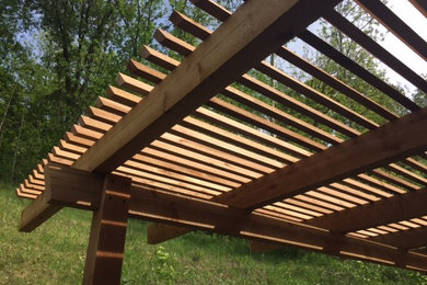 Huge backyard deck photo in Other with a pergola