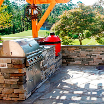 Outdoor Kitchen with Red Green Egg and Stone Patio
