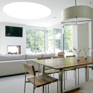 Photo of a medium sized rural open plan dining room in New York with white walls, marble flooring, a standard fireplace, a concrete fireplace surround and grey floors.