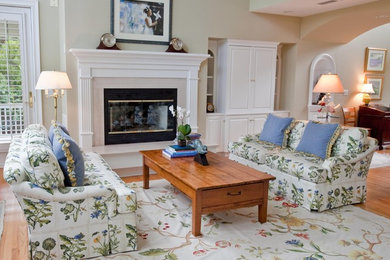 This is an example of a large traditional open concept living room in Charleston with beige walls, medium hardwood floors, a standard fireplace and a stone fireplace surround.