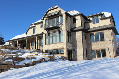 Large elegant beige three-story mixed siding exterior home photo in Other