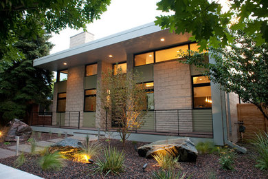 Large modern two-storey beige house exterior in Denver with mixed siding and a flat roof.