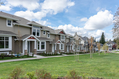 Example of a mid-sized arts and crafts brown three-story townhouse exterior design in Vancouver