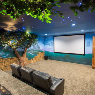 Eclectic enclosed carpeted home theater photo in Salt Lake City with multicolored walls and a media wall