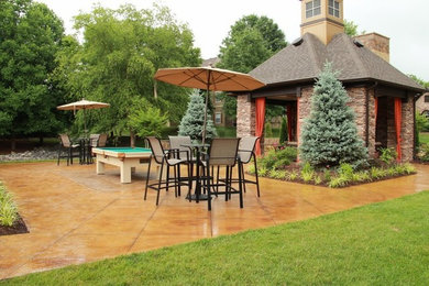 Example of a mid-sized backyard stamped concrete patio kitchen design in Nashville with a gazebo
