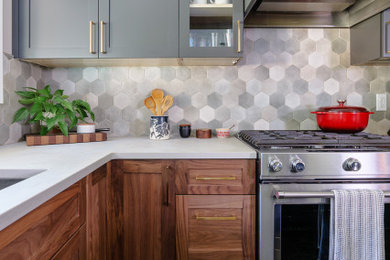 Inspiration for a mid-sized craftsman l-shaped concrete floor, black floor and exposed beam eat-in kitchen remodel in Portland with an undermount sink, shaker cabinets, gray cabinets, quartz countertops, gray backsplash, porcelain backsplash, stainless steel appliances, an island and beige countertops