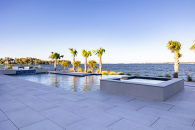 Inspiration for a huge backyard rectangular infinity hot tub remodel in Atlanta with decking