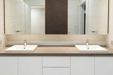 Inspiration for a modern bathroom in Perth with a drop-in sink and engineered quartz benchtops.