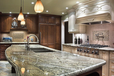 Large transitional u-shaped terra-cotta tile and multicolored floor eat-in kitchen photo in Calgary with recessed-panel cabinets, granite countertops, beige backsplash, stainless steel appliances, an island, an undermount sink, medium tone wood cabinets and mosaic tile backsplash