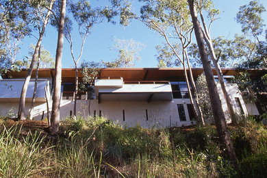 Photo of a country home design in Brisbane.