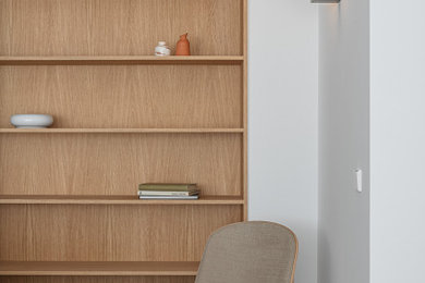 Imagen de sala de estar con biblioteca abierta moderna de tamaño medio con paredes blancas, suelo de baldosas de cerámica y suelo gris