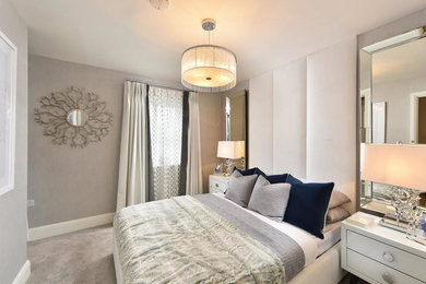 This is an example of a large traditional master bedroom in Surrey with grey walls, carpet, no fireplace and grey floors.
