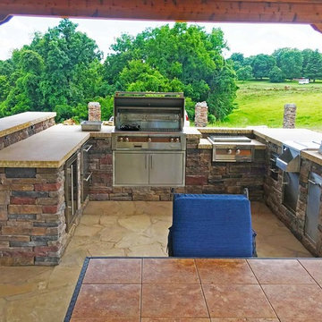 Outdoor kitchen on flagstone patio.