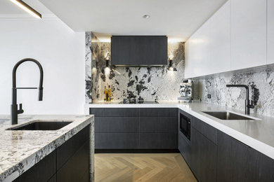 This is an example of a mid-sized modern l-shaped open plan kitchen in Sydney with a single-bowl sink, flat-panel cabinets, dark wood cabinets, granite benchtops, multi-coloured splashback, granite splashback, panelled appliances, light hardwood floors, with island, yellow floor and multi-coloured benchtop.
