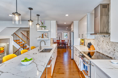 Enclosed kitchen - mid-sized contemporary galley enclosed kitchen idea in DC Metro with an undermount sink, flat-panel cabinets, white cabinets, quartzite countertops, gray backsplash, ceramic backsplash, stainless steel appliances and white countertops