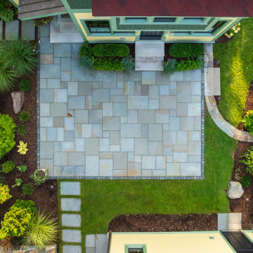 The backyard from above: raised grade, bluestone patio, planted screen