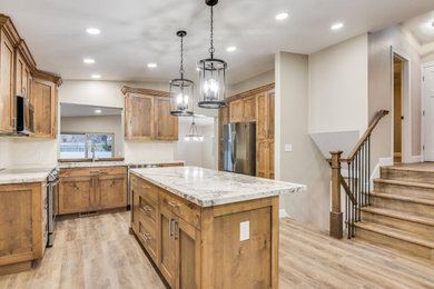 Mid-sized u-shaped vinyl floor and brown floor eat-in kitchen photo in Salt Lake City with an undermount sink, shaker cabinets, medium tone wood cabinets, quartzite countertops, white backsplash, ceramic backsplash, stainless steel appliances, an island and multicolored countertops