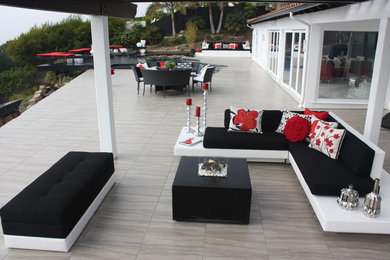 Large contemporary backyard patio in Los Angeles with a gazebo/cabana and tile.