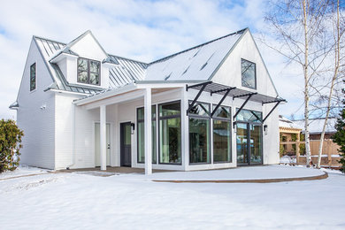 Example of a small farmhouse white two-story concrete fiberboard gable roof design in Seattle