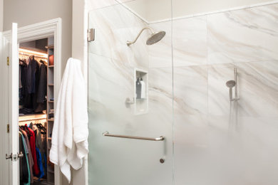 Example of a mid-sized master multicolored tile and porcelain tile porcelain tile, brown floor and double-sink alcove shower design in Atlanta with recessed-panel cabinets, dark wood cabinets, gray walls, an undermount sink, quartz countertops, a hinged shower door, white countertops, a niche and a built-in vanity