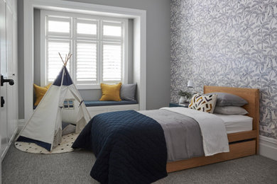 This is an example of a large contemporary kids' room for kids 4-10 years old and boys in Sydney with grey walls, carpet and grey floor.