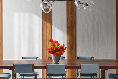 Contemporary dining room in New York with medium hardwood floors.