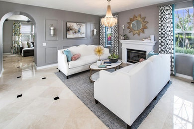 Family room - mid-sized transitional enclosed marble floor and beige floor family room idea in Orange County with gray walls, a standard fireplace and a plaster fireplace