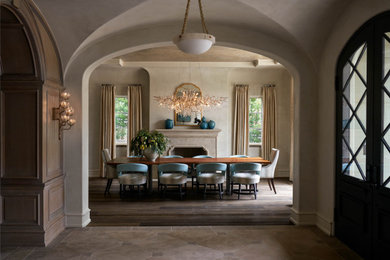 Inspiration for a mediterranean dining room remodel in Dallas with a stone fireplace