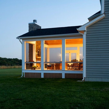 Design Builders screened porch with stone fireplace & Ipe deck in Sykesville MD