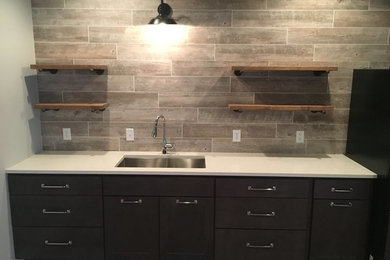 Basement - mid-sized traditional medium tone wood floor and brown floor basement idea in Other with gray walls