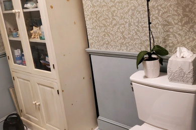 Example of a mid-sized ornate wallpaper powder room design in New York with a freestanding vanity