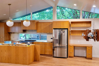 Example of a large mid-century modern single-wall light wood floor and wood ceiling eat-in kitchen design in Dallas with flat-panel cabinets, light wood cabinets and an island