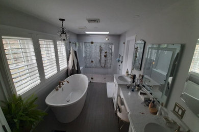 Inspiration for a mid-sized modern 3/4 bathroom remodel in Philadelphia with glass-front cabinets and a freestanding vanity