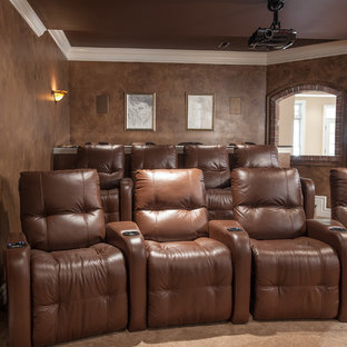 Mid-sized tuscan enclosed carpeted and beige floor home theater photo in St Louis with brown walls and a projector screen