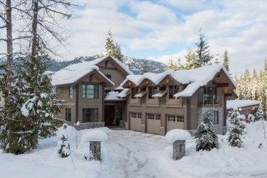 Huge arts and crafts beige three-story wood exterior home photo in Vancouver with a metal roof