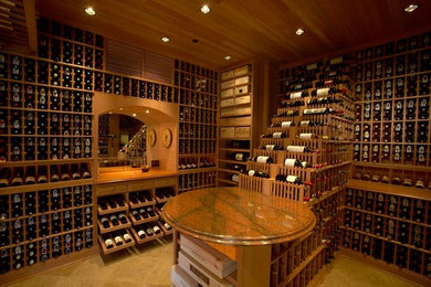 This is an example of a large traditional wine cellar in Los Angeles with terra-cotta floors and display racks.