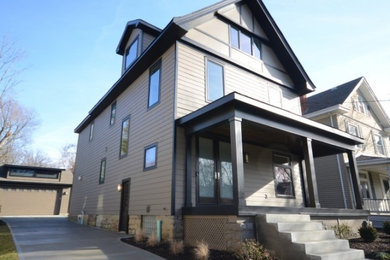 Example of a mid-sized trendy brown three-story exterior home design in Cincinnati