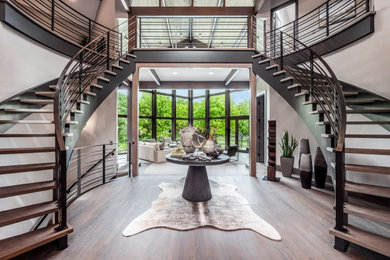 Large mountain style medium tone wood floor, gray floor and wood ceiling foyer photo in Columbus with beige walls