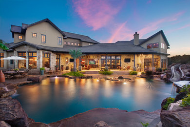 Inspiration for a large eclectic beige two-story mixed siding exterior home remodel in Austin