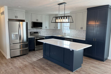 Mid-sized trendy vinyl floor kitchen photo in Other with an undermount sink, shaker cabinets, blue cabinets, quartzite countertops, gray backsplash, ceramic backsplash, stainless steel appliances, an island and white countertops