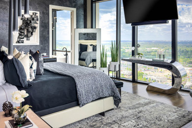 Large trendy master dark wood floor and brown floor bedroom photo in Houston with black walls