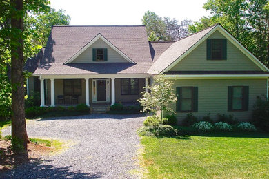 Example of a large arts and crafts beige two-story wood exterior home design in Charlotte with a shingle roof