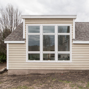 This is an example of a large modern craft room in Chicago with multi-coloured walls, concrete flooring, a freestanding desk and grey floors.