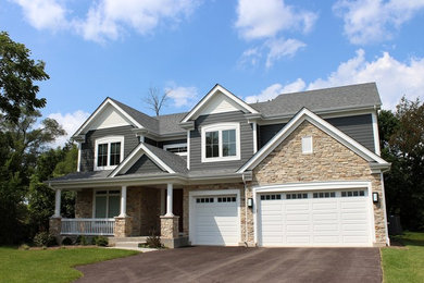 Example of a large gray two-story mixed siding gable roof design in Chicago