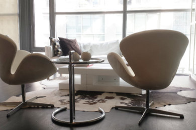 Inspiration for a mid-sized modern enclosed dark wood floor living room remodel in Toronto with white walls